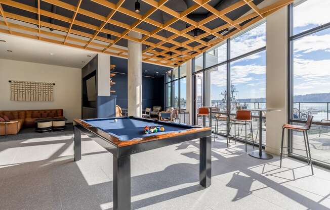 Game Lounge with a pool table, lounging couches, and floor to ceiling windows at Marina Square, WA 98337