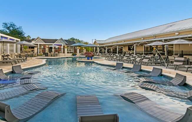 the resort style pool with lounge chairs at the resort at governors residence at Crossgates Apartment Homes, Starkville