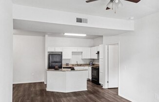 Living room with view of kitchen at Tidwell Estates in Houston TX