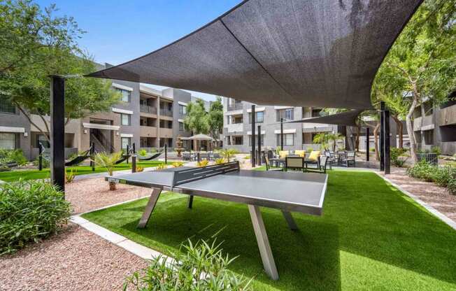 a ping pong table in the courtyard of an apartment complex