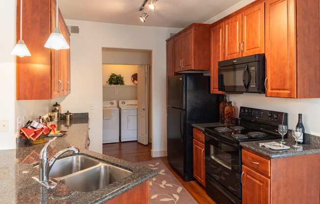 a kitchen with wood cabinets and black appliances