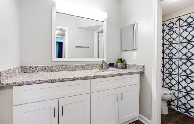 a bathroom with white cabinets and granite countertops at Barcelo at East Cobb, Marietta, Georgia