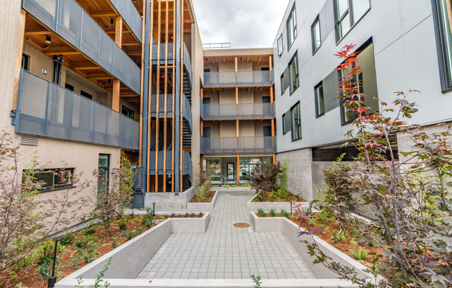 Apartments for Rent in Southeast Portland, OR - The Lenox - Outdoor Living Courtyard with Meticulously Groomed Grounds and Exterior of Apartment Homes