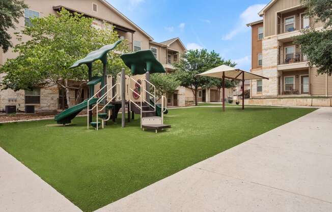our apartments have a play area with a slide and grass