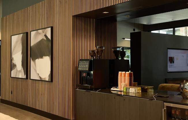 A reception area with a wooden panel and two framed pictures on the wall.