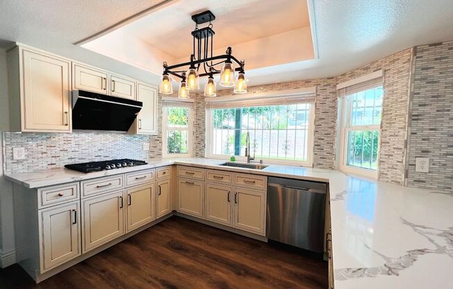 Gorgeous 4 Bed 2.5 Bath in a prime location! Home is over 2200 Sq Ft with a pool on a huge lot! Separate living room, dining room, and family room! Beautiful kitchen with stainless steel appliances built into the white cabinets!