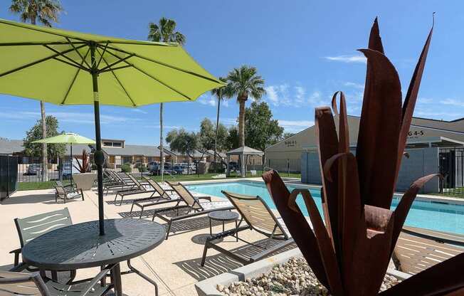 a swimming pool with tables and umbrellas