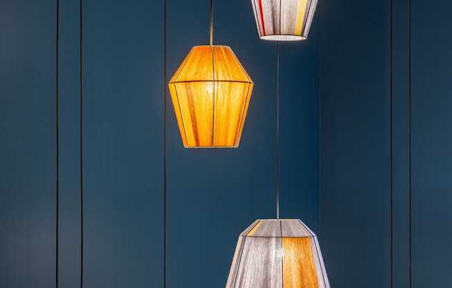 Five hanging lamps with different shapes and designs are suspended from the ceiling.