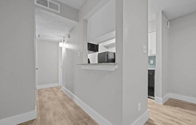 A kitchen area with a refrigerator, microwave, and oven.