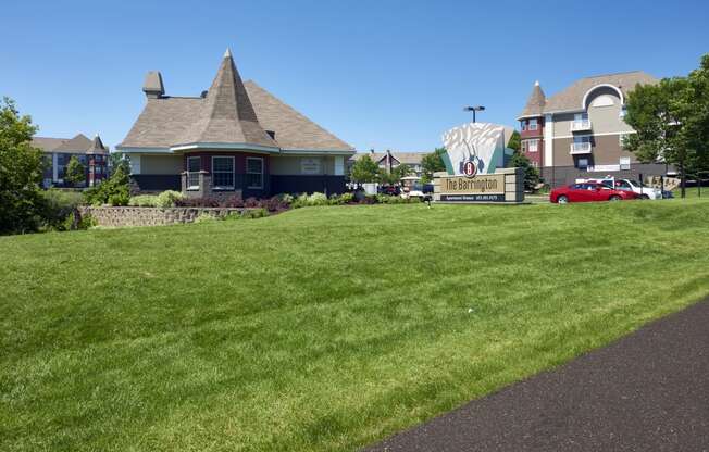 a large lawn in front of a house with a sign for a movie theater