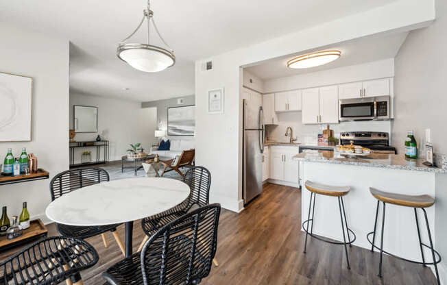 A modern kitchen with a dining table and chairs.