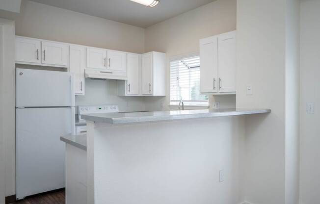 Village at Main Street | 2x2 Kitchen with White Cabinetry and Appliance and Eat In Counter