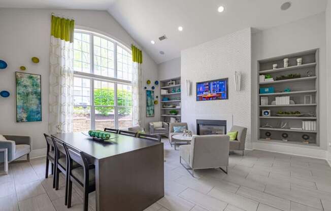 A modern kitchen with a large island and a TV mounted on the wall.
