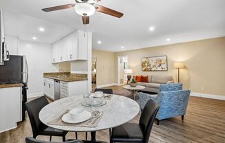 A modern kitchen with a dining table set for two