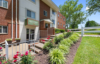 A red brick building with a green sign that says Bren Mar Apartments.