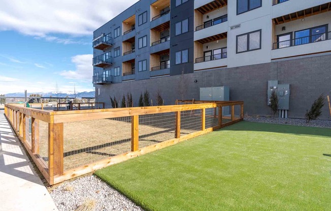 A large grassy area in front of a building.