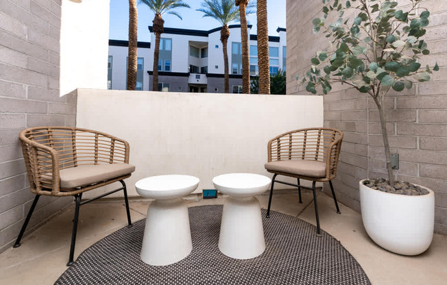 Two white toilets are in the middle of a patio.