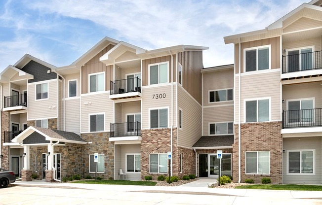 a row of apartment buildings with balconies and a street