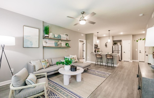 an open living room and kitchen with a ceiling fan