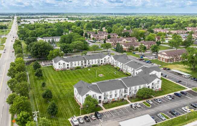 A large white building with a green lawn in front of it