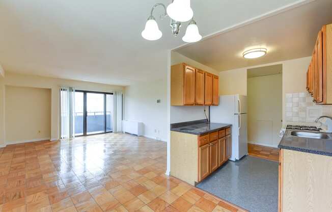 kitchen with wood cabinetry, gas range and view of living area at twin oaks apartments columbia heights washington dc