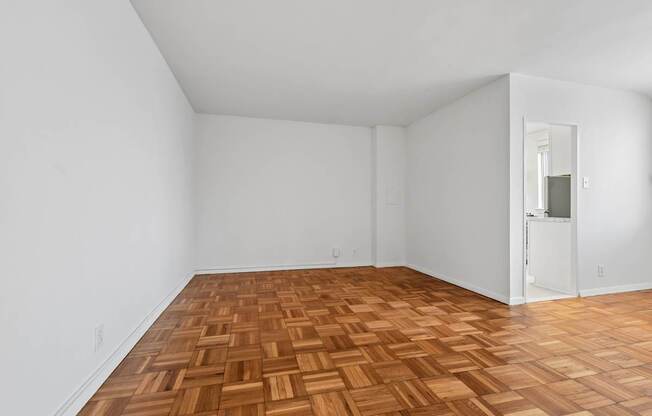 A room with a wooden floor and white walls.