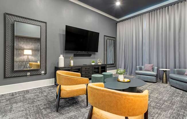 a living room with a tv and a table and chairs at Madison on the Meadow, Stafford, TX, 77477