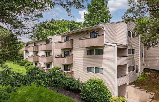 A large apartment complex with a green lawn in front.