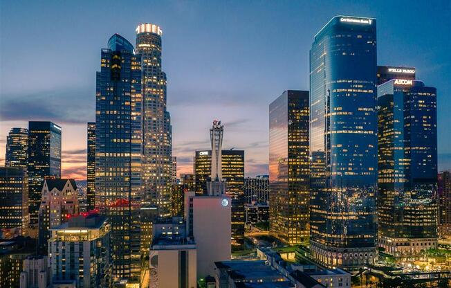 a view of the downtown los angeles skyline at dusk