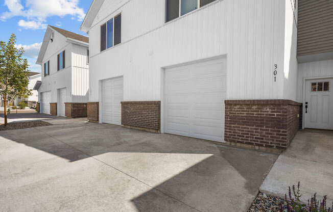 a white garage door on the side of a building