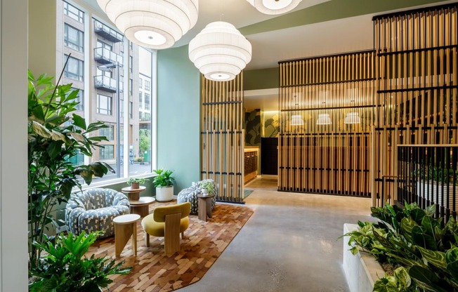 a lobby with a seating area and plants at Slabtown Square Apartments, Portland ,Oregon, 97209