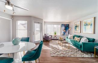 a living room with a green couch and a white table