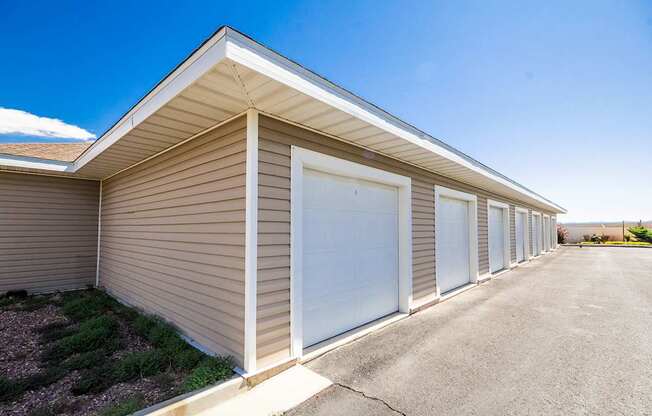 A long building with a brown siding and a white roof.