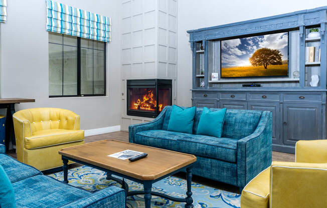 a living room with couches and a coffee table and a fireplace