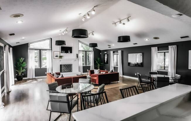 a living room with black walls and a white table and chairs Indy