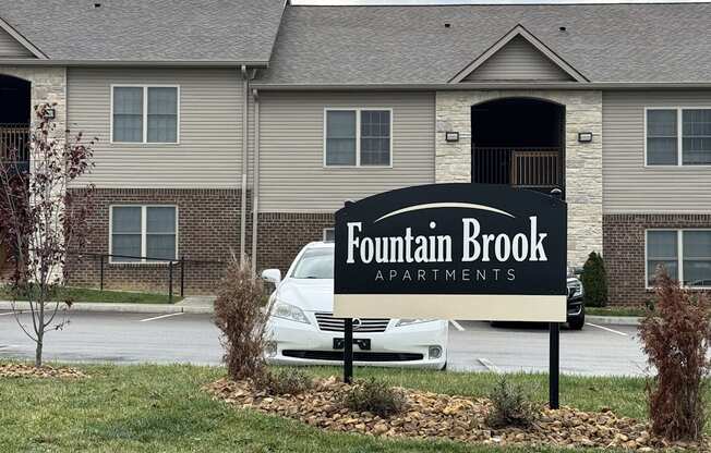 a sign that reads foundation brook apartments in front of a house