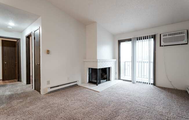 A living room with a fireplace and a carpet. at Bristol Ridge, Urbandale, IA