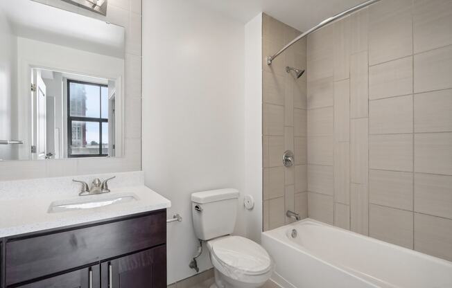 a bathroom with a toilet sink and tub and a shower