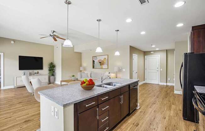 A kitchen with a counter top and a bowl of fruit on it.
