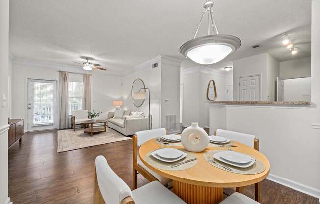 A dining room with a round table set for six.