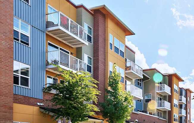 A sunny day at a modern apartment complex with a clear blue sky.