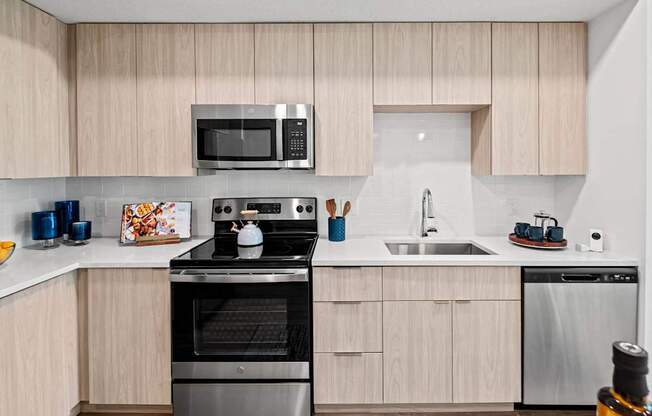 A modern kitchen with wooden cabinets and stainless steel appliances.