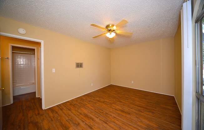 Ponderosa Apartments unfurnished bedroom with ceiling fan