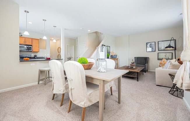 A dining room with a table and chairs.