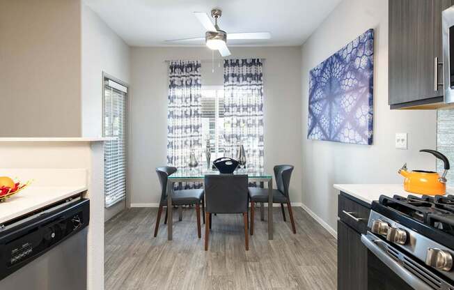 a kitchen and dining room area with a table and chairs and a stove