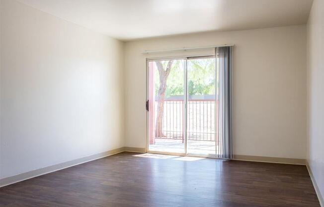 Living Room with Hardwood Style Flooring and Private Balcony Access