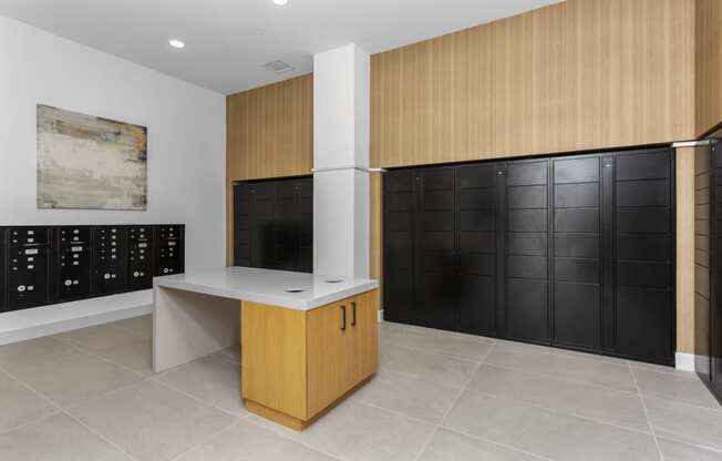 a wine room with black lockers and a counter and a wall of cabinets