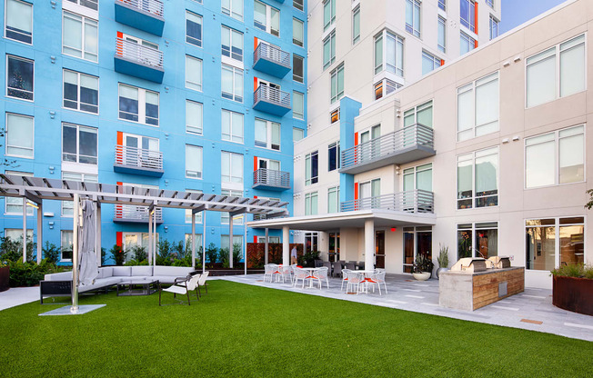 Apartments overlooking outdoor kitchen and lounge on amenity deck at Lake Nona Pixon, Orlando, 32827