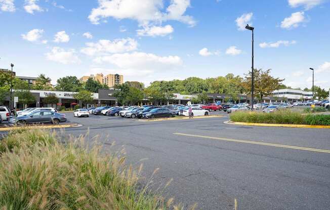 A parking lot with cars and a building in the background.