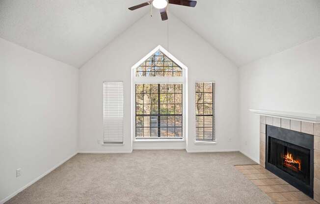 A room with a fireplace and a ceiling fan.